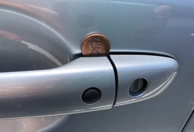 Here’s Why Finding a Penny in Your Car Door Handle Could Be a Serious Warning  Have you ever encountered the peculiar and somewhat bewildering situation where you approach your vehicle only to find a penny lodged in the door handle? This seemingly random occurrence has left many questioning its significance or whether it’s just an odd coincidence.  It turns out, this can be a clever tactic employed by car thieves. Let’s unravel the mystery behind this cunning stratagem and learn how to outsmart these audacious perpetrators. Get ready to become savvy in car security!  The Cunning Penny Gambit  You may have heard that car thieves have an array of tricks up their sleeves, and one of their favorites involves a simple penny or nickel.  Read more on next page